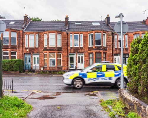 Motion blur as a police car passes a lane on Crow Road in Jordanhill, Glasgow.